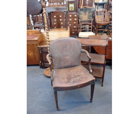 A MAHOGANY FRAMED DESK CHAIR WITH LEATHER UPHOLSTERY a barley twist standard lamp, and a three-tier trolley