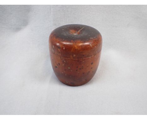 A TURNED BURRWOOD BOX OR CADDY of stylised apple form, with surface patina 9 cm high (stalk missing)