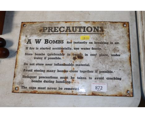 An enamel "AW Bombs Precaution" sign