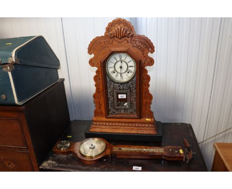 A Weathermaster barometer and an oak cased two hole clock