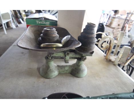 A small set of scales and various iron and brass weights
