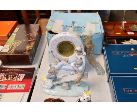 A Lladro mantel clock case and Lladro figure group (two children on a seesaw)