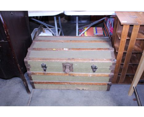 A wooden and metal bound canvas travelling trunk 