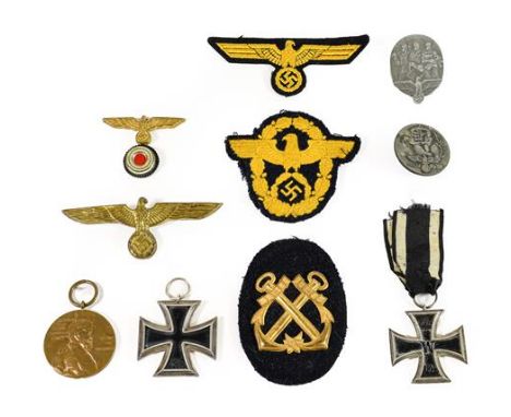 A Collection of German Third Reich Militaria, comprising a Second World War Iron Cross, second class, the suspender ring stam