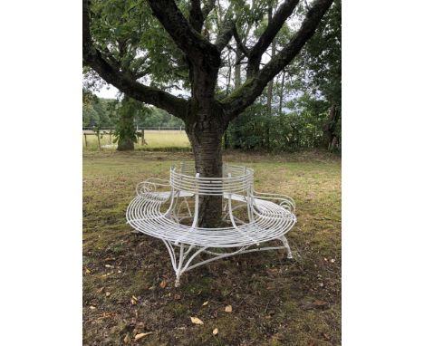 Garden seats: An Arras wrought iron tree seat in two halves, early 20th century, with maker’s plaque, 182cm diameter