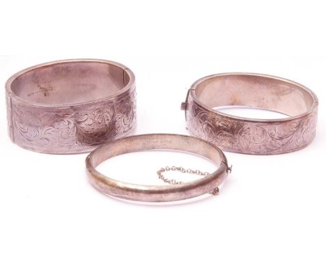 Mixed Lot: two hallmarked silver hinged bracelets, the wide bangle fully engraved with a scroll design, the other part engrav