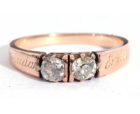 Two-stone diamond ring featuring two old cut diamonds, each individually in coronet settings, raised between engraved shoulde