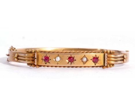Antique ruby and seed pearl hollow hinge bracelet, the top section with three round cut rubies and two small seed pearls, eac