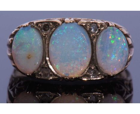 9ct gold opal and diamond ring, a design featuring three graduated oval shaped opals, highlighted between with four small dia