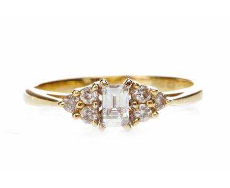 DIAMOND DRESS RINGset with a central rectangular mixed cut diamond of approximately 0.15 carats flanked by two groups of thre