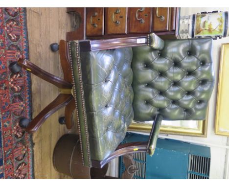 *A leather button back office armchair, adjustable and on castors