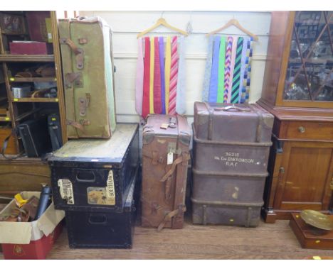 A leather travelling trunk, a canvas trunk, two metal bound trunks and another trunk, all marked for Wing Commander D.W. Rows