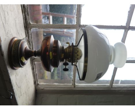 A brass and copper oil lamp with opaque glass shade, 48cm high