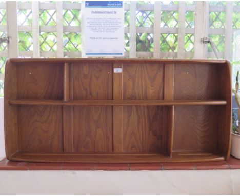 An Ercol style oak wall unit 106.5cm wide