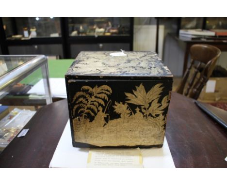 An early 19th century penwork box of chinoserie design containing seven drawers of red wax Classical cameos, with typed label