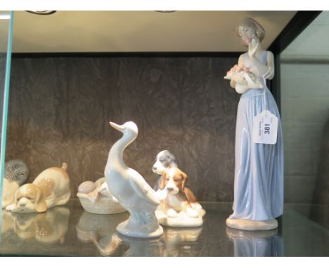 A Lladro figure of a goose with goslings in a basket 10cm wide, another of a dog 15cm high and seven Nao figures, including a