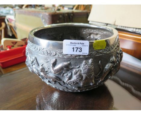 An Indian silvered metal bowl depicting hunting and sports in relief, unmarked 20cm diameter
