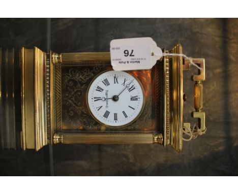 *A brass carriage clock retailed by Mappin &amp; Webb, the circular enamel dial within fluted columns on a plinth base, the t