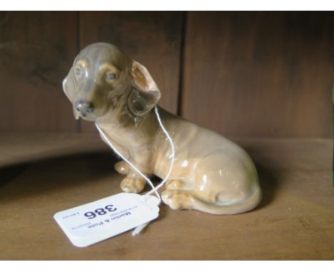 A Royal Copenhagen model of a seated Daschund lopped ear puppy figurine 3140