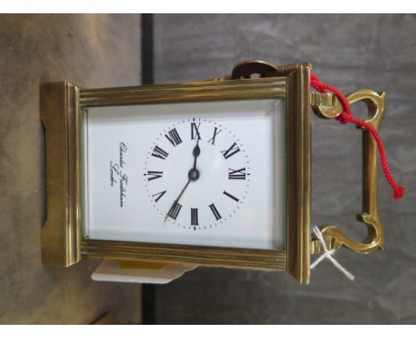 A brass carriage clock time piece, retailed by Charles Frodsham, 15cm high