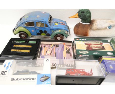 A box of vintage model vehicles including tin plate VW Beetle, Corgi Double Deck closed tram, and other examples. Some boxed.