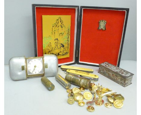 A travel clock, two pen knives, a lighter, buttons, etc.  **PLEASE NOTE THIS LOT IS NOT ELIGIBLE FOR IN-HOUSE POSTING AND PAC