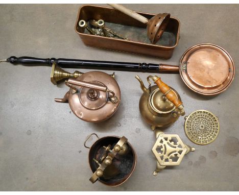 A collection of copper and brassware including a kettle, bedpan, copper planter, candlesticks and other examples **PLEASE NOT