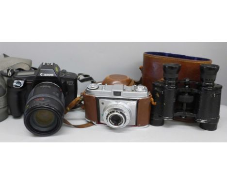 A pair of French made binoculars, a Kodak Retinette camera in leather case and a Canon EOS 650 with 35-135 lens