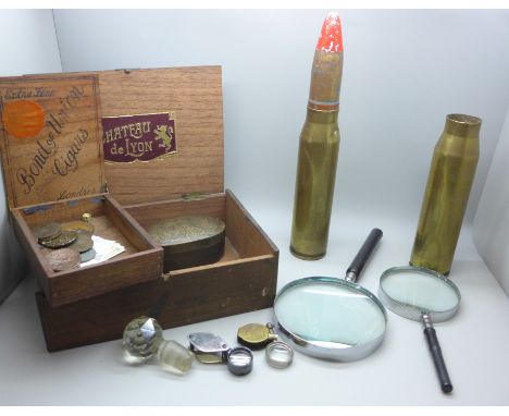 Two magnifying glasses, two eye glasses, two brass shells, a Chinese faux tortoiseshell box, coins and decanter stopper