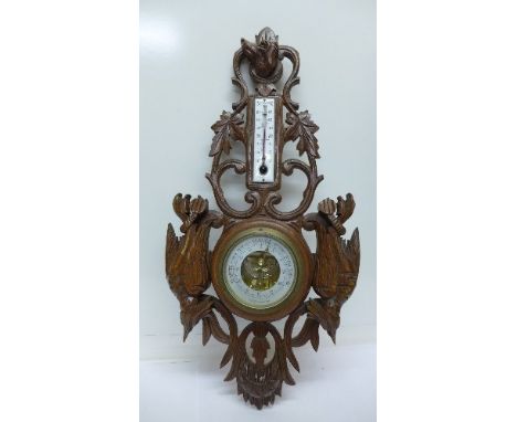 A carved framed aneroid barometer, Black Forest