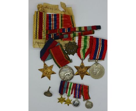 A set of four WWII medals including Africa Service Medal to 135917 E.J.H. Yates with miniatures, spare ribbons, badges and a 