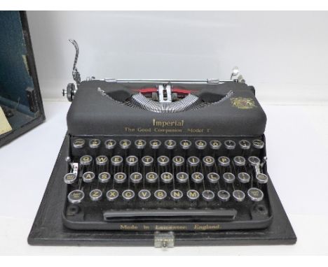 An Imperial typewriter, cased, model T, with Good Companion Instruction Book, a Touch Typewriting Guide and a brush
