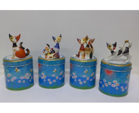 Four Goebel cat figures, with tins