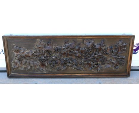 Early 20th century rectangular wooden wall panel, relief decorated with grape vines, 49 x 139cm .       