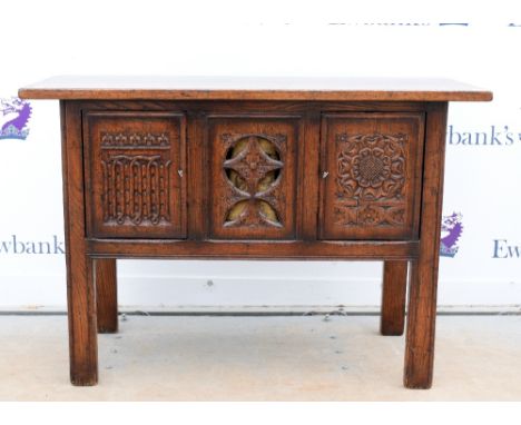 Tudor style century style oak side cupboard, two floral carved cupboard doors flanking pierced and carved panel, 84 x 122 x 4