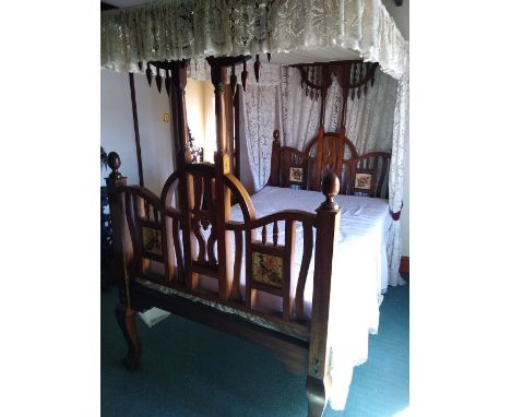 Early 20th century mahogany bed with cloth panel to top, the headboard and footboard inset with tile-like decoration,.       