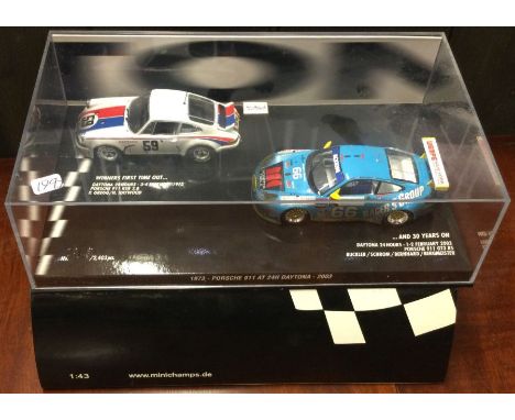 MINICHAMPS: A presentation case containing two 1:43 scale Porsche 911 model race cars. Est. £20 - £30.