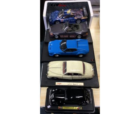 Four 1:18 scale unboxed model cars together with one other. Est. £20 - £30.