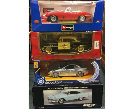 Four boxed 1:18 scale model cars. Est. £20 - £30.