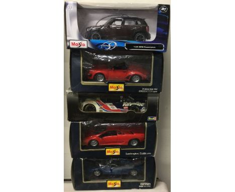 Five various 1:18 scale boxed model cars. Est. £20 - £30.