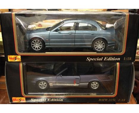 MAISTO: Two 1:18 scale boxed model cars. Est. £20 - £30.