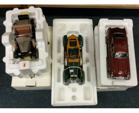 Three various 1:24 scale boxed model cars. Est. £20 - £30.