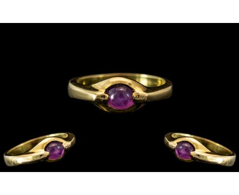 18ct Gold Amethyst Set Dress Ring, Central cabachon amethyst, shank stamp 750. 