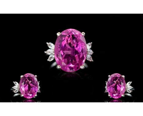 Magenta Pink Triplet Quartz and Topaz Ring, the striking, magenta pink, oval cut, 10ct stone flanked by three marquise cut wh