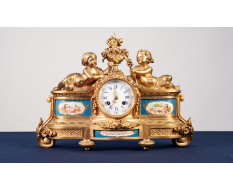 A LATE NINETEENTH CENTURY FRENCH GILDED SPELTER CASED SEVRES STYLE PORCELAIN INSET MANTEL CLOCK, the movement striking on a b