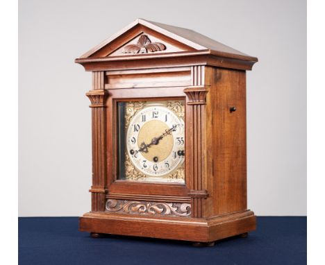 TWENTIETH CENTURY CARVED WALNUT MANTLE CLOCK, the 6 ½" brass dial with silvered Arabic chapter ring, matted gilt centre and p