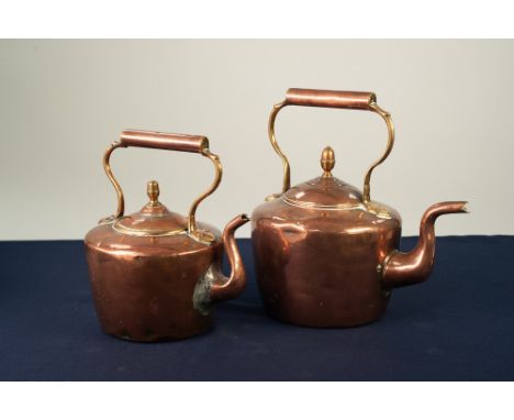 A LARGE NINETEENTH CENTURY COPPER KETTLE, the lid with acorn finial, 12" high and ANOTHER SLIGHTLY SMALLER, 10" high