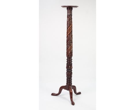 NINETEENTH CENTURY CARVED MAHOGANY TORCHERE, the moulded circular top above a spira fluted column carved with acanthus leaves