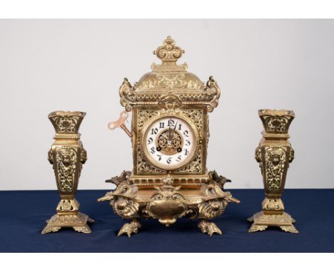 LATE NINETEENTH/ EARLY TWENTIETH CENTURY EMBOSSED BRASS MANTLE CLOCK, the 3 ½" Arabic dial with pierced brass centre, powered