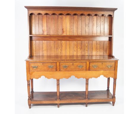 LATE EIGHTEENTH CENTURY OAK SMALL DRESSER, the back with moulded cornice, shaped frieze and single shelf, the advanced lower 